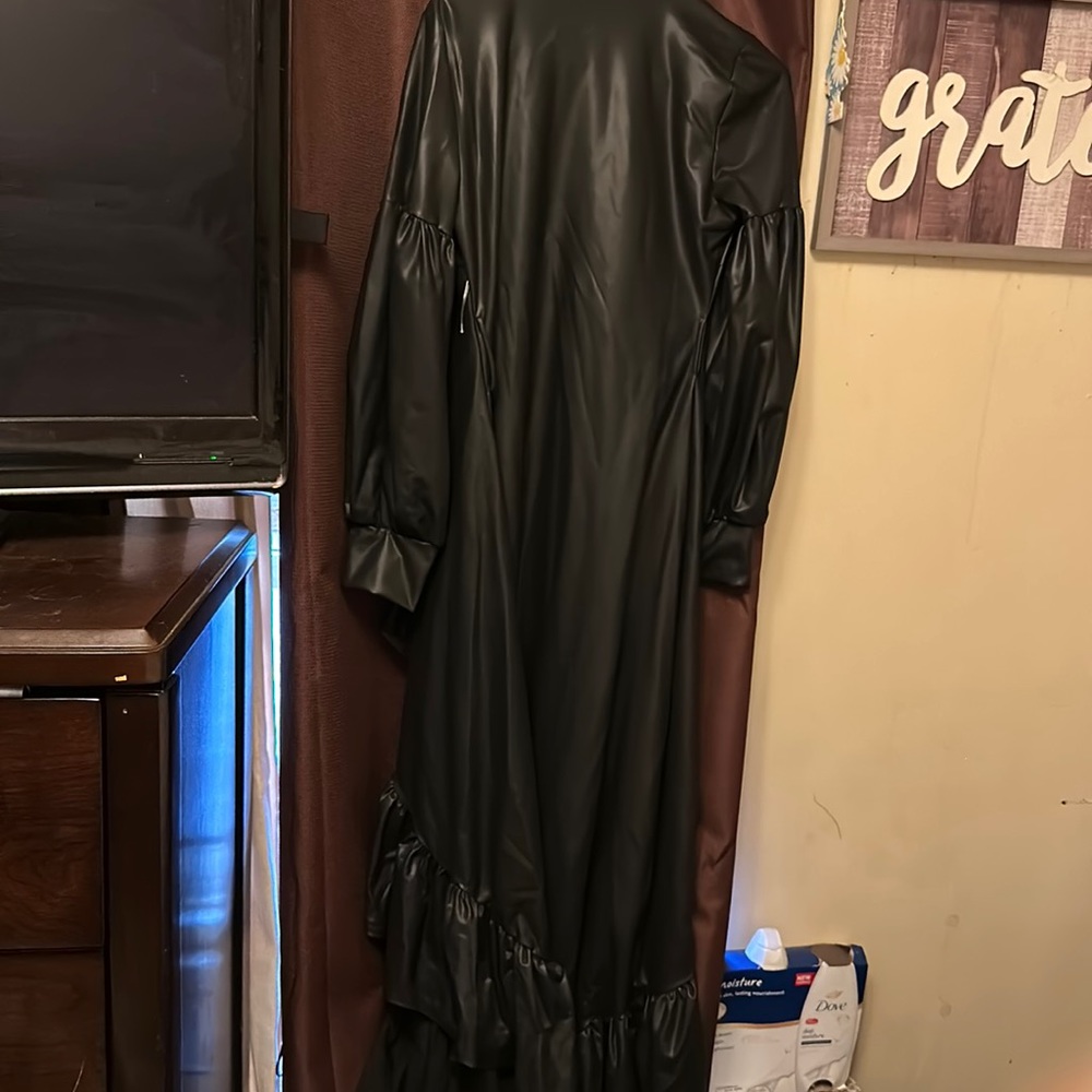 Black leather coat with ruffles.